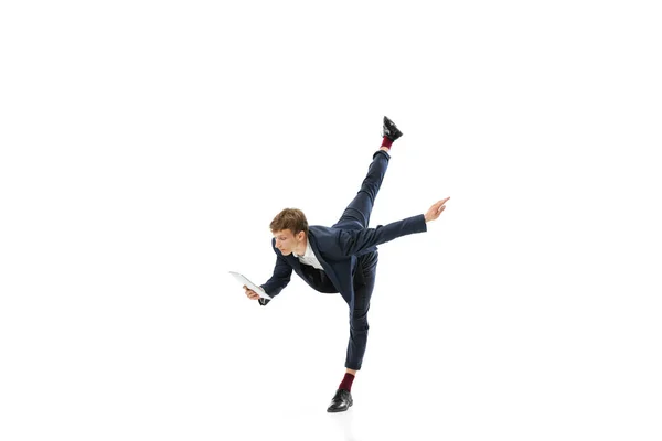 Man in office style clothes dancing and using tablet isolated on white studio background. Business, start-up, open-space, inspiration concept. — ストック写真