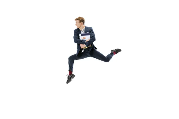 Jovem de terno de negócios escuro pulando, voando isolado no fundo branco. Arte, movimento, ação, flexibilidade, conceito de inspiração. — Fotografia de Stock