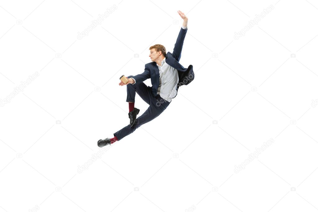 Studio shot of young male ballet dancer wearing business suit dancing isolated on white studio background. Business, start-up, art, work, caree, inspiration concept.