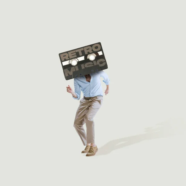 Contemporary art collage. Man in official cloth with retro music cassette dancing isolated over light gray background — Photo