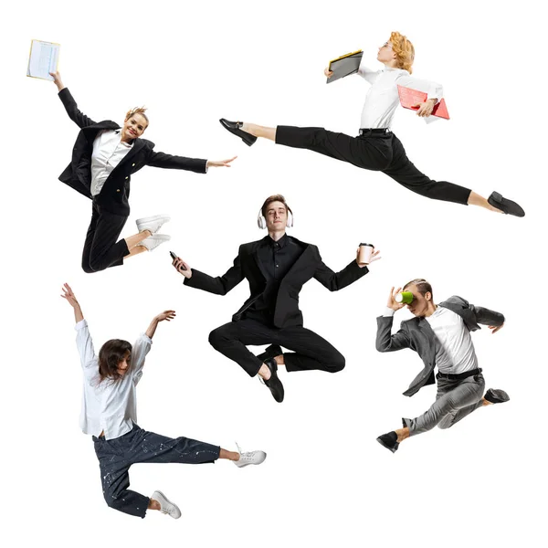 Young office workers jumping and dancing in busness style clothes or suit with folders and gadgets on white background. Creative collage. — Stock Photo, Image