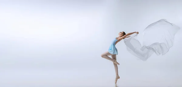 Flyer with young girl, aspiring ballerina in blue dress and pointes dancing with cloth isolated on gray background. Art, grace, beauty, ballet school concept — Photo