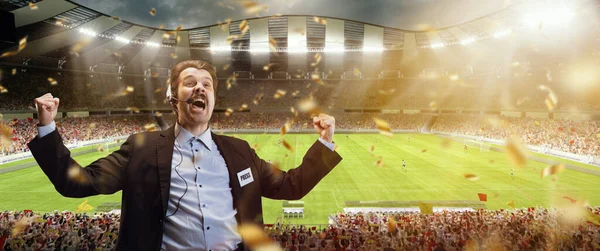 Happy man, professional sport commentator having online broadcast of football match isolated over sport stadium background — Stock Photo, Image