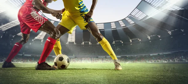 Cropped image of two soccer, football players in motion, action at stadium during football match. Concept of sport, competition, goals — Stock Photo, Image