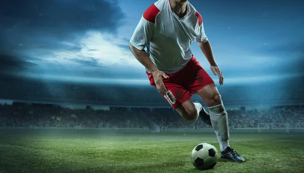 Cropped image of running soccer, football player at stadium during football match. Concept of sport, competition, goals