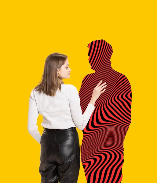 Portrait of young woman touching silhouette of man with hypnotic design isolated over yellow background. Mix photo and illustration — Stock Photo, Image