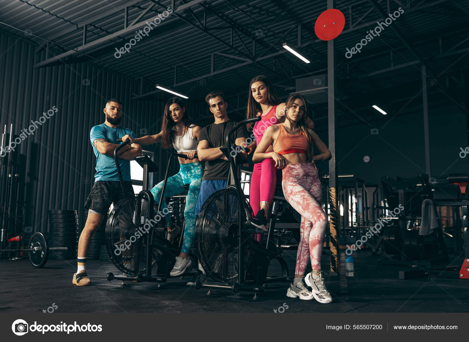 Group of young friends doing sports training at gym indoors