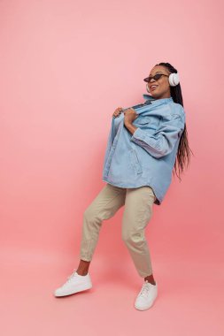 Pembe arka planda izole edilmiş gündelik kıyafet giymiş kadın modelin portresi. Güzellik, sanat, moda, gençlik kavramı