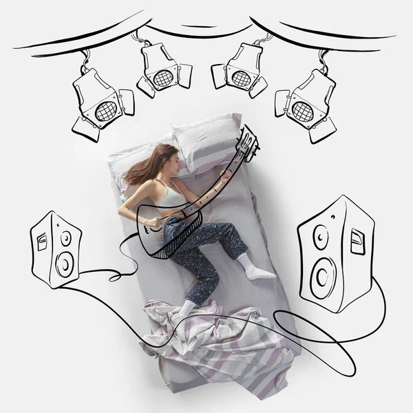 Creative image. Top view of young woman lying on bed, sleeping, dreaming about beign rock musician, playing on stage — Photo