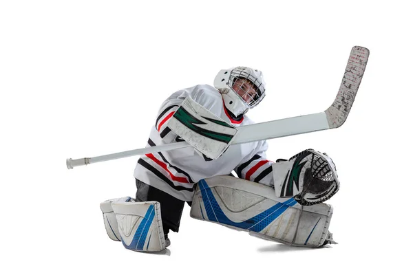 Full-length portrait of young boy, hockey player training, goalkeeper in action isolated over white studio background — Stock Photo, Image