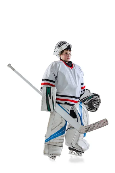 Full-length portrait of young boy, hockey player in special protective uniform of goalkeeper isolated over white studio background — Stock Photo, Image