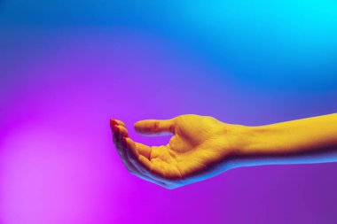 Aetentik insan elinin stüdyo görüntüsü neon ışıkla izole edilmiş mor-mavi arkaplanda. İnsan ilişkileri, toplum, birliktelik kavramı