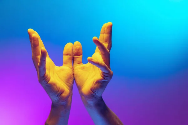 Pray for peace. Human hands gesturing on gradient blue and purple background in neon. Concept of human rights, social issues, gathering. —  Fotos de Stock