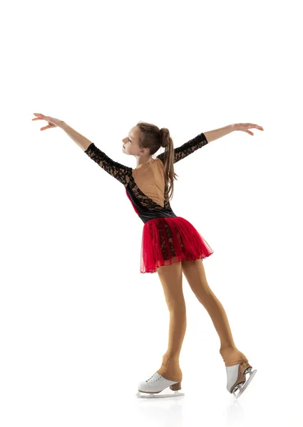 Portrait of little flexible girl, figure skater wearing stage attire posing isolated on white studio background. Concept of movement, sport, beauty. — Stock Photo, Image