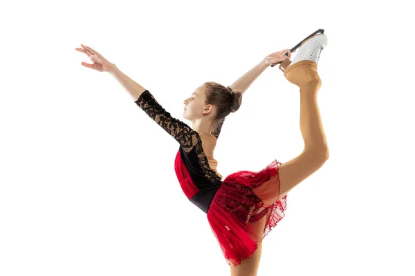 Portrait of little flexible girl, figure skating wearing stage attire posing isolated on white studio backgound. Concept of movement, sport, beauty. — Photo