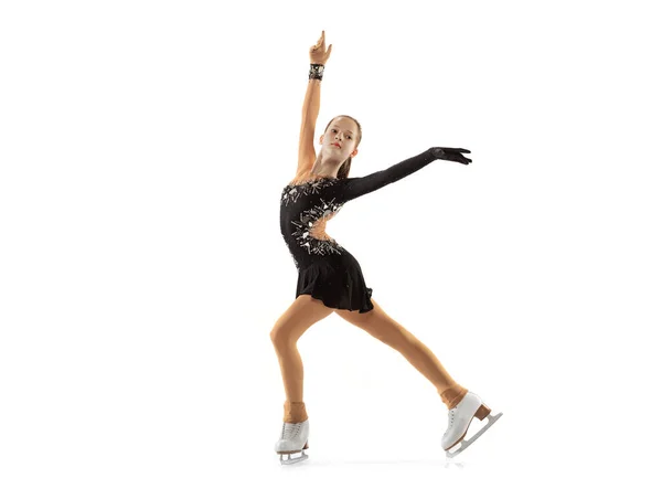 Portrait of little flexible girl, figure skating wearing stage attire posing isolated on white studio backgound. Concept of movement, sport, beauty. — Stock Photo, Image
