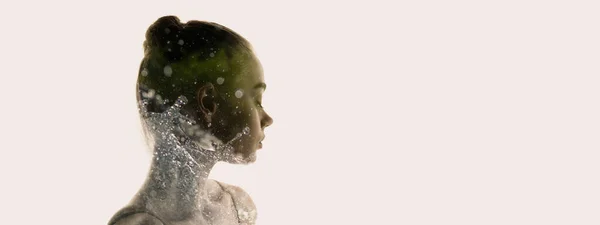 Conceptual image. Transparent silhouette of young tender woman and water splashes around grass isolated over grey background Stock Picture