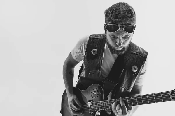 Black and white portrait of stylish man, rock musician with electric guitar isolated on white background. Rehearsal base Concept of art, music, style — Stockfoto