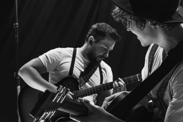 Repetition of rock music band at music studio. Cropped image of electric and acoustic guitar players at concert. Rehearsal base Concept of art, music, style — 스톡 사진