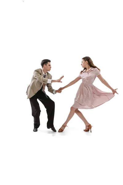 Young man and woman in vintage retro style outfits dancing social dance isolated on white background. Timeless traditions, 1960s american fashion style and art — Stock Photo, Image