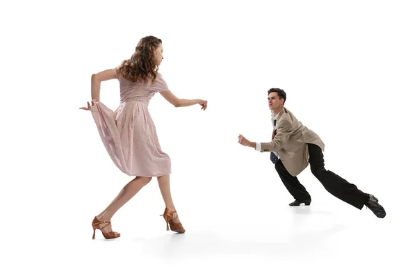 Young man and woman in vintage retro style outfits dancing social dance isolated on white background. Timeless traditions, 1960s american fashion style and art — Photo