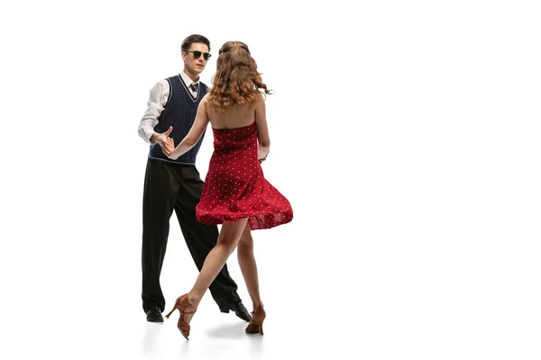 Quickstep. Beautiful girl and stylish man in vintage retro style outfits dancing isolated on white background. Timeless traditions, 60s,70s american fashion style and art — Stok fotoğraf