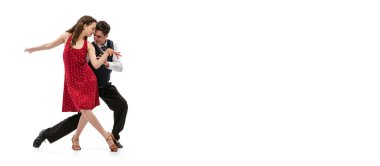 Beyaz arka planda izole bir şekilde dans eden eski moda kıyafetlerle güzel bir kız ve şık bir adam. Zamansız gelenekler, 60 'lar, 70' ler Amerikan moda tarzı ve sanatı