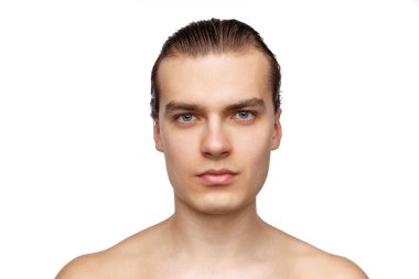Close-up portrait of young handsome man isolated on white studio background. Concept of mens health, beauty, self-care, body and skin care.