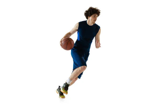 Dynamic portrait of young man, basketball player playing basketball isolated on white background. Concept of sport, movement, energy and action — Stockfoto