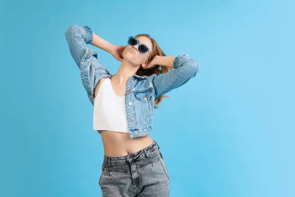 Portrait of young pretty happy girl in casual style outfit isolated on blue background. Concept of beauty, art, fashion, youth, spring collection — 图库照片