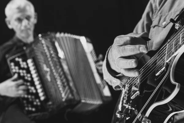 Black and white portrait of two senior men, musicians with guitar and accordion at music studio. Concept of art, music, style and creation. Monochrome — 스톡 사진