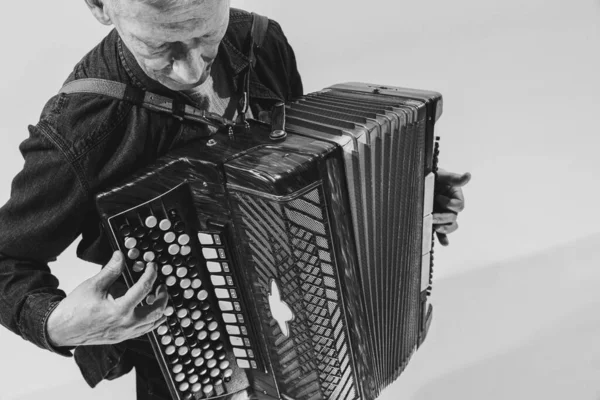 Monochrome portrait of seniot man, retro musician playing the accordion isolated on white background. Concept of art, music, style, older generation, vintage — Stock Photo, Image