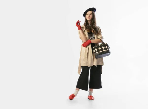 Portrait of beautiful young girl, teen in retro style clothes posing at white studio background. Concept of emotions, art, beuty, youth, vintage — стоковое фото