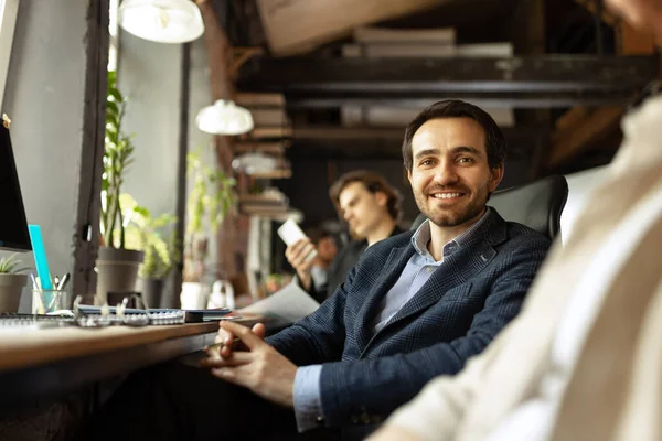 Senior developer. Happy man looking at camera and smilling. Work in modern loft style office using devices and gadgets during job processing. — Fotografia de Stock