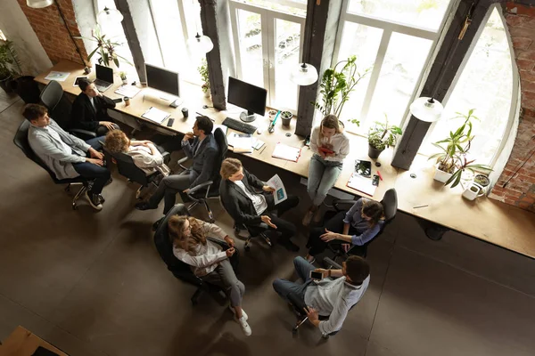 Young people talking, working with colleagues, co-workers at loft style office. Business, urban lifestyle, work, finance, tech concept. Aerial view — Stok Foto