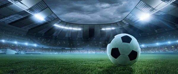Collage with soccer football ball lying on grass of football field at crowded stadium with spotlight in evening. Concept of sport, art, energy, power