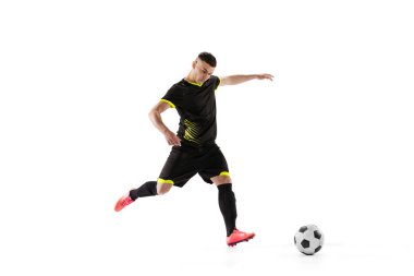 Hareket halindeki profesyonel erkek futbol oyuncusu ve beyaz stüdyo arka planında izole edilmiş aksiyon. Spor anlayışı, hedefler, rekabet, hobi, reklam, dünya kupası. Siyah futbol takımı giyen sporcular