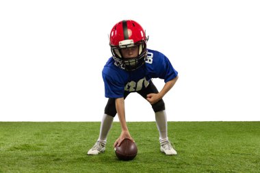 Başlangıç pozisyonu. Atletik çocuk, beyaz arka planda izole edilmiş spor üniformalı Amerikan futbolcusu ve kask eğitimi. Spor kavramı, zorluklar, eylem, başarılar.