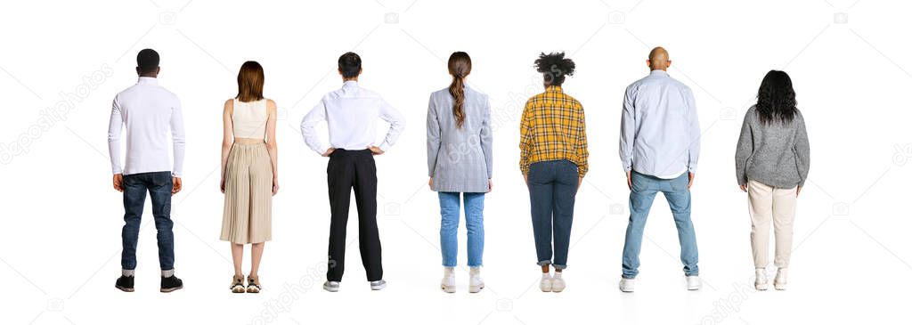 Back view of young men and women standing together like team isolated over white background. Horizontal flyer. Models in casual clothes. Work, study, team, fashion, diversity, human rights