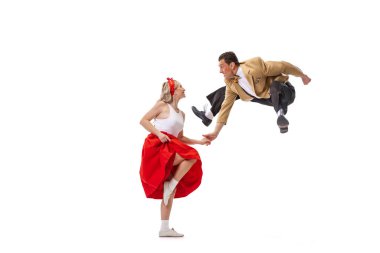 Dynamic portrait of dancing couple in vintage style clothes dancing, jumping isolated on white background. Concept of art, music, 60s ,70s american fashion style. Emotions, expressions clipart