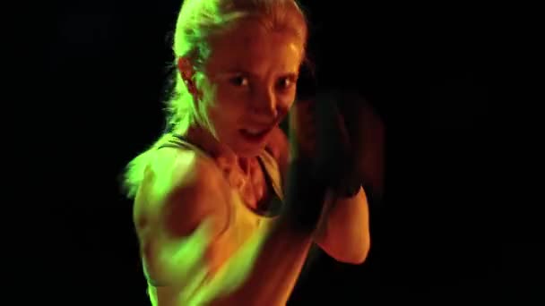 Closeup Female Professional Boxer Practices Punch Isolated Dark Smoky Background — Stok video