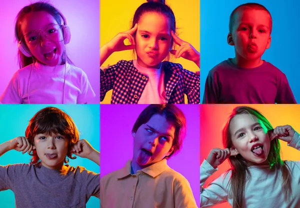 Making faces, grimace. Set of portraits of little cute kids, boys and girls isolated on multicolored background in neon light. Education, wow emotions, facial expression and childhood concept.