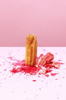 Sweet lifes. Food pop art photography. Image of delicious french eclair with strawberry filling cream isolated over pink background. Vintage, retro style. Complementary colors, Copy space for ad, text