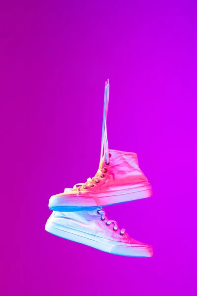 Image Fashionable Sports Shoes Sneakers Isolated Colored Neon Background Urban — стоковое фото