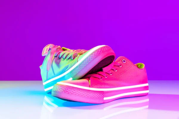 Image Fashionable Sports Shoes Sneakers Isolated Colored Neon Background Urban — стоковое фото