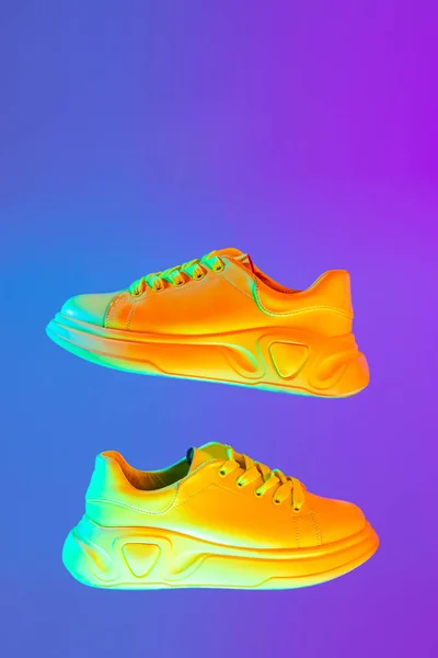 Image Fashionable Sports Shoes Sneakers Isolated Colored Neon Background Urban — Φωτογραφία Αρχείου