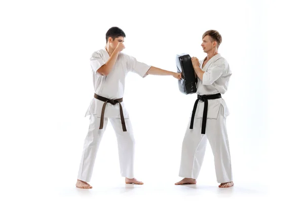Shotokan Karate Two Athletes Karate Fighters Doboks Practicing Karate Isolated — Stockfoto