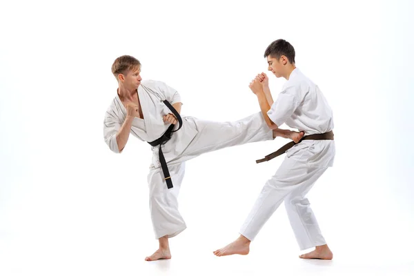 Leg Kick Two Athletes Karate Fighters Doboks Practicing Karate Isolated — 图库照片