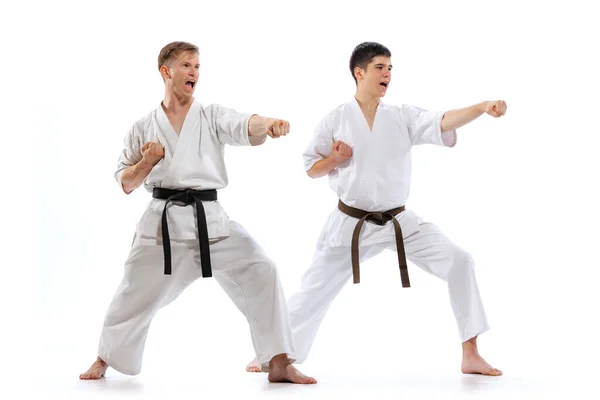 Gyaku Zuki Two Athletes Karate Fighters Doboks Practicing Karate Isolated — стокове фото