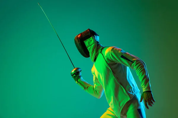 Studio Shot Young Man Fencer Smallsword Practicing Fencing Isolated Green — стоковое фото